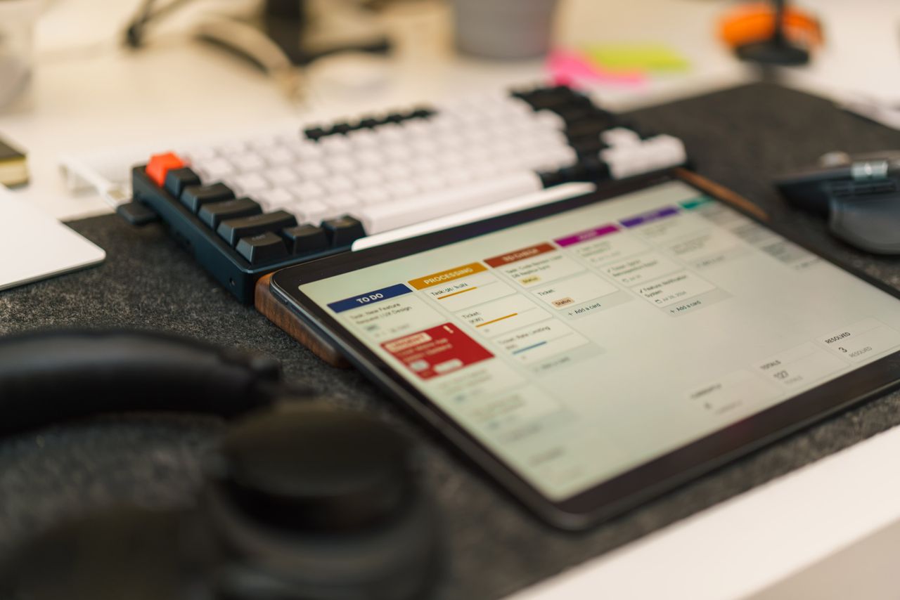 Services Tech-focused workspace featuring a tablet, mechanical keyboard, and productivity app for efficient task management.